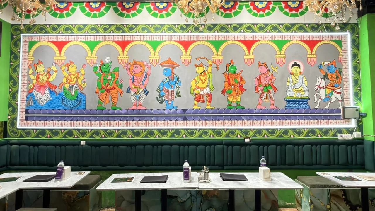 The dining room in Sector 135, green walls and brass lamps